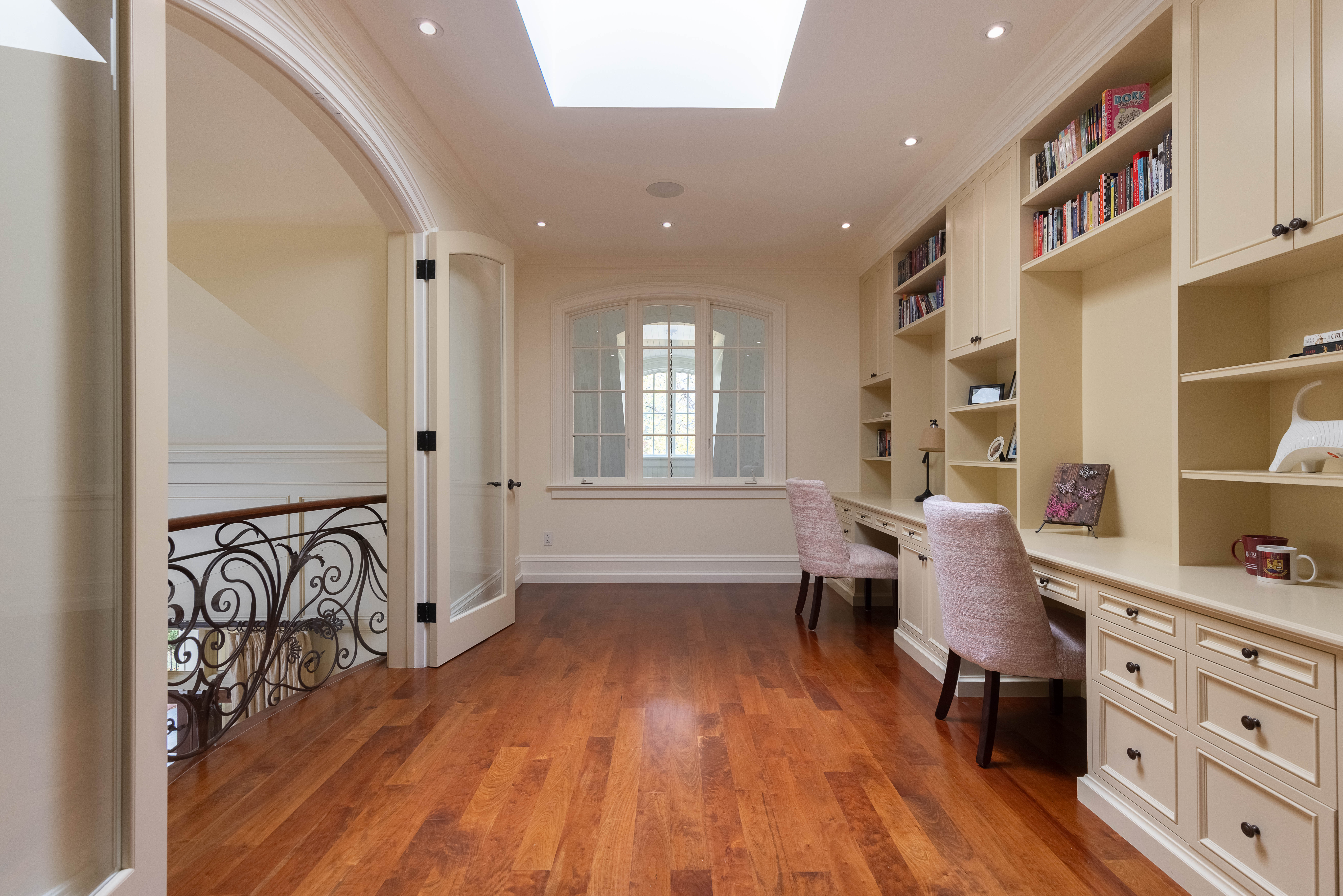 Bright home office with built-in shelves and wooden flooring