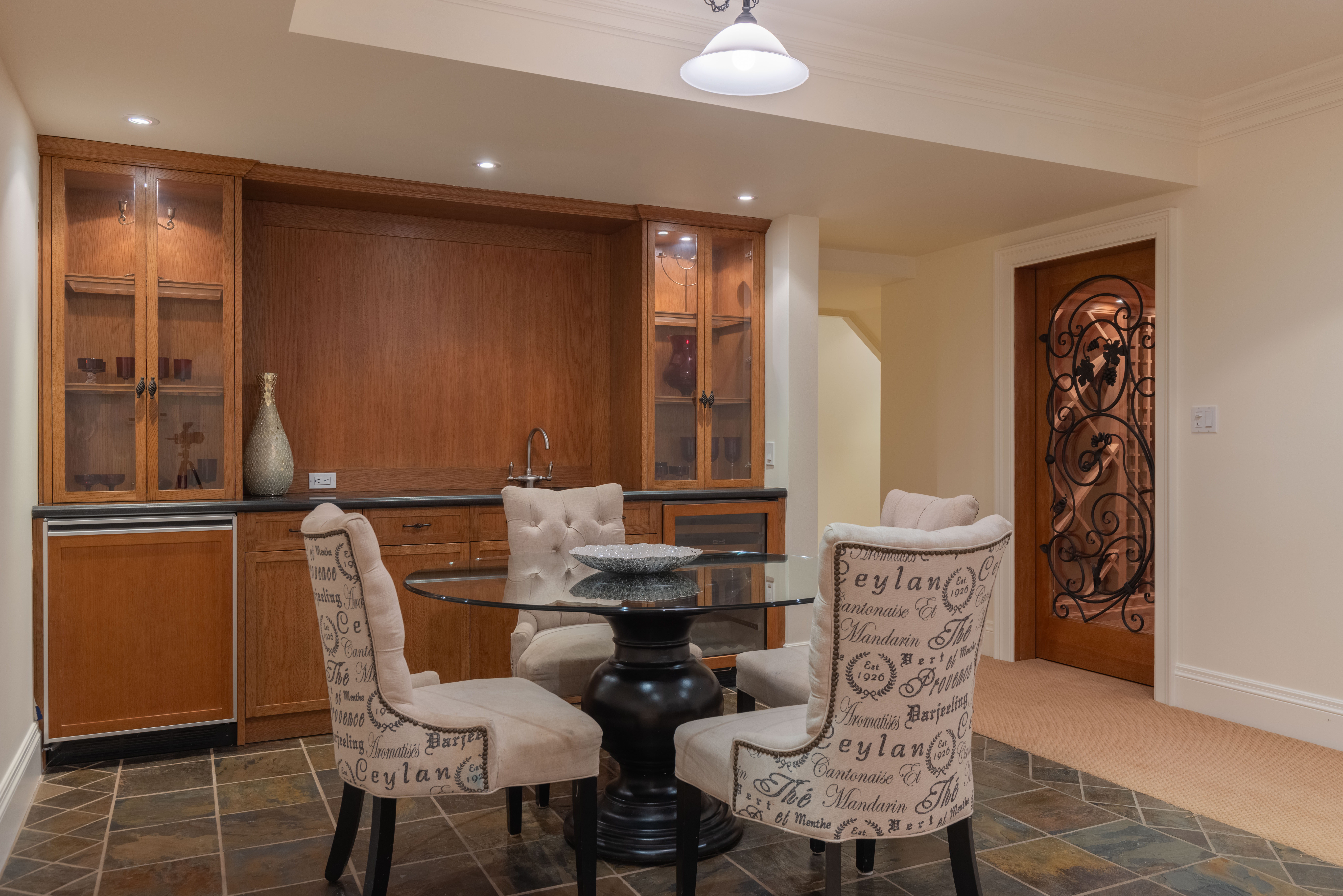 Modern dining area with a glass table and upholstered chairs