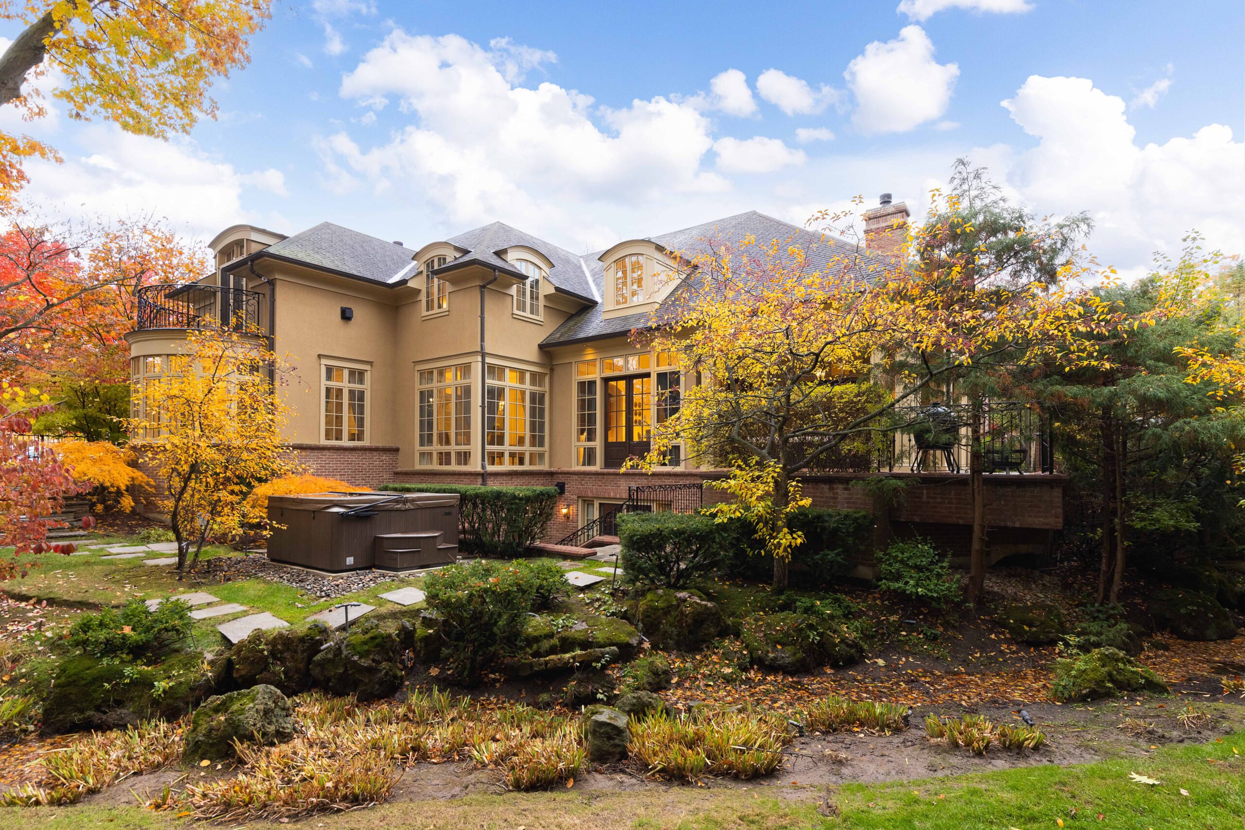 Elegant house surrounded by autumn foliage and landscaped garden