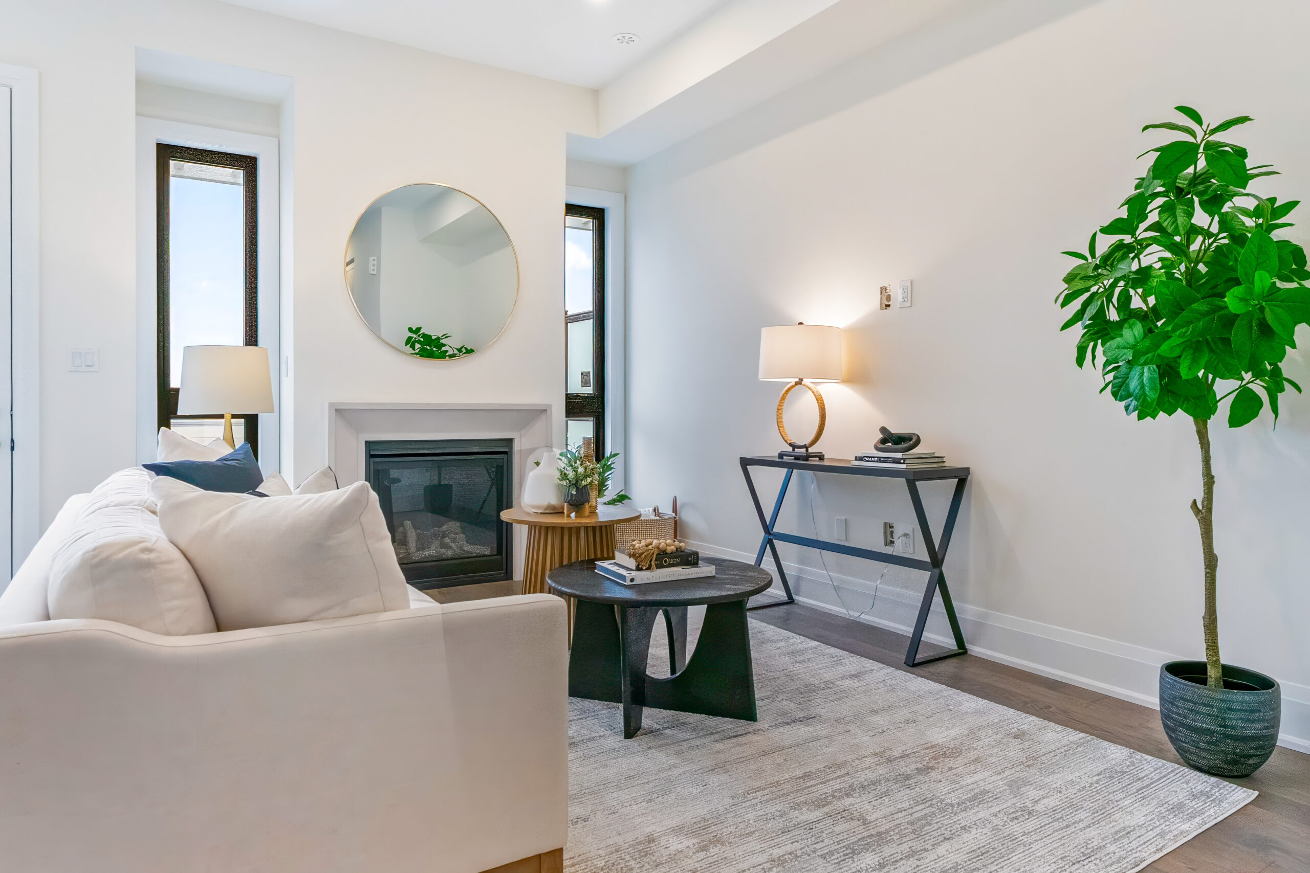 Bright living room with a white sofa, plants, and modern decor