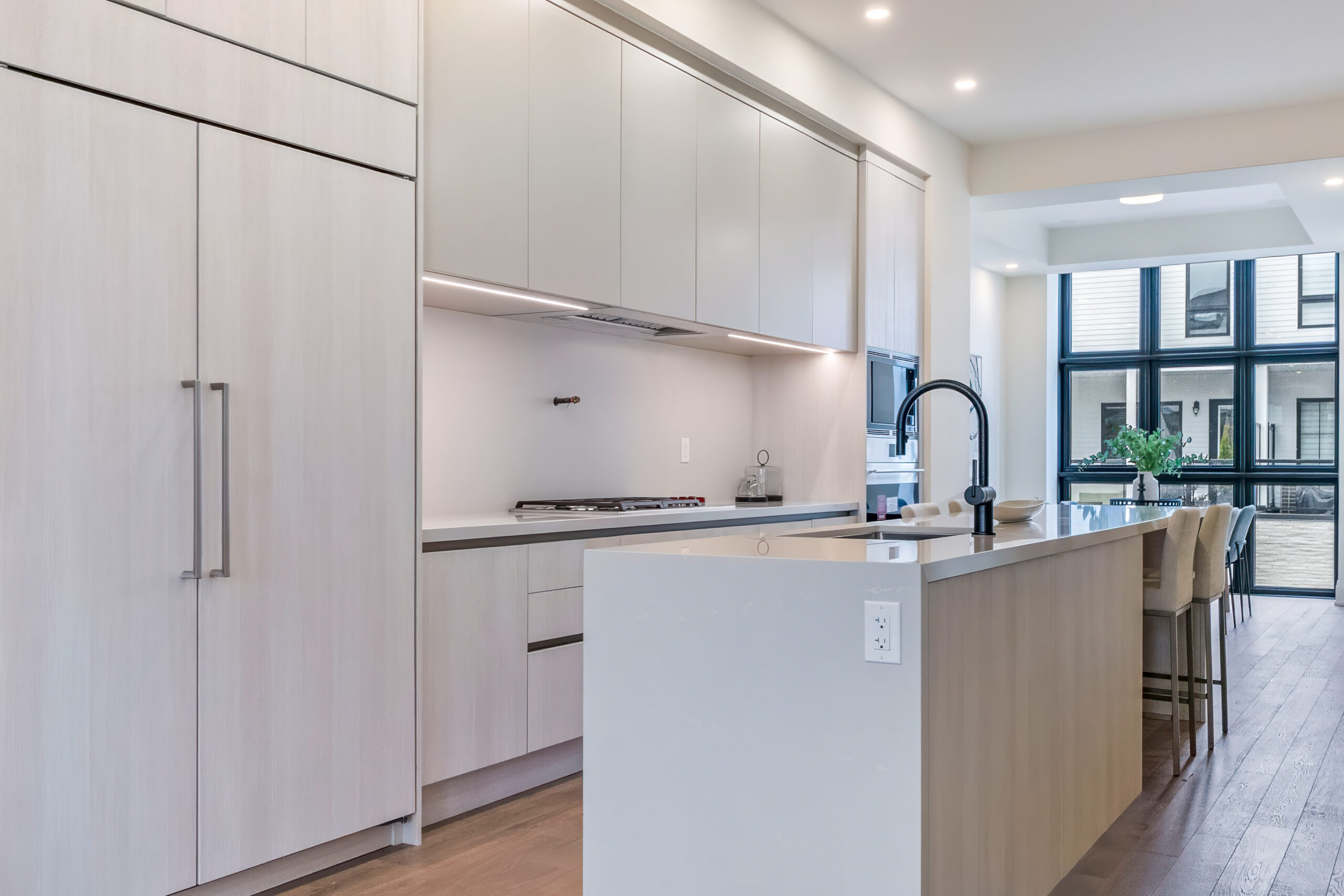 Modern kitchen with light wood cabinetry and a large island