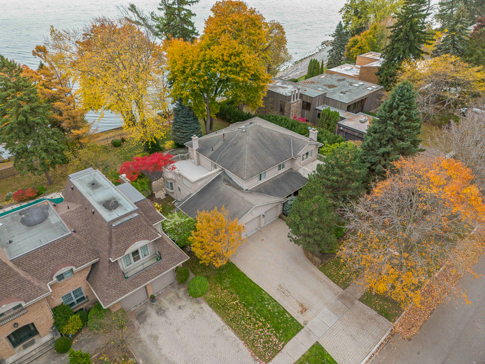 Aerial view of a residential area with autumn foliage and nearby lake