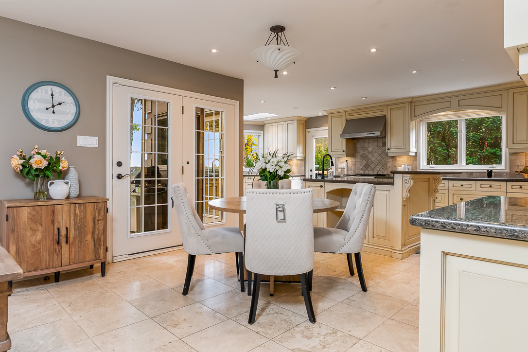 Modern kitchen and dining area with a round table and elegant decor