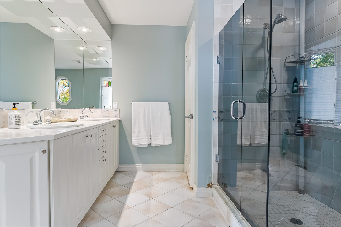 Modern bathroom with a glass shower and double vanity sinks