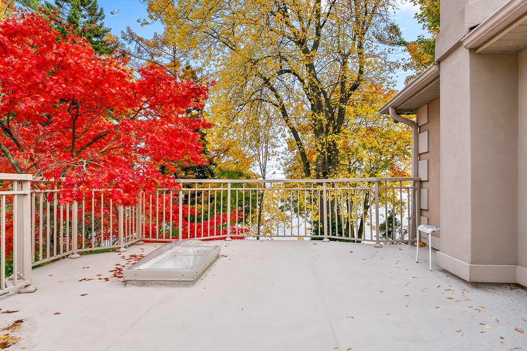 Balcony view with vibrant red and yellow autumn foliage