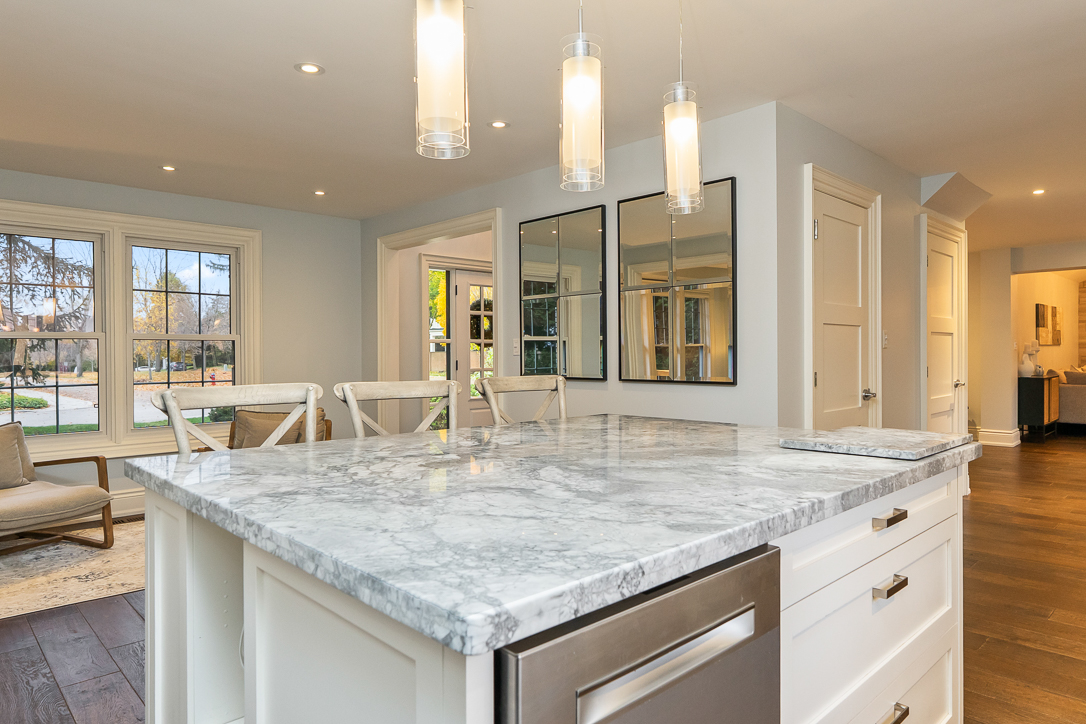 Modern kitchen with marble island and pendant lighting