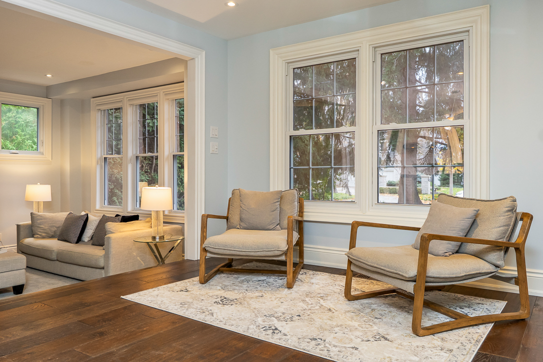 Cozy living room with two armchairs and large windows