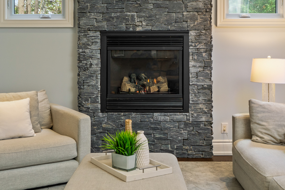 Cozy living room with a stone fireplace and modern furniture