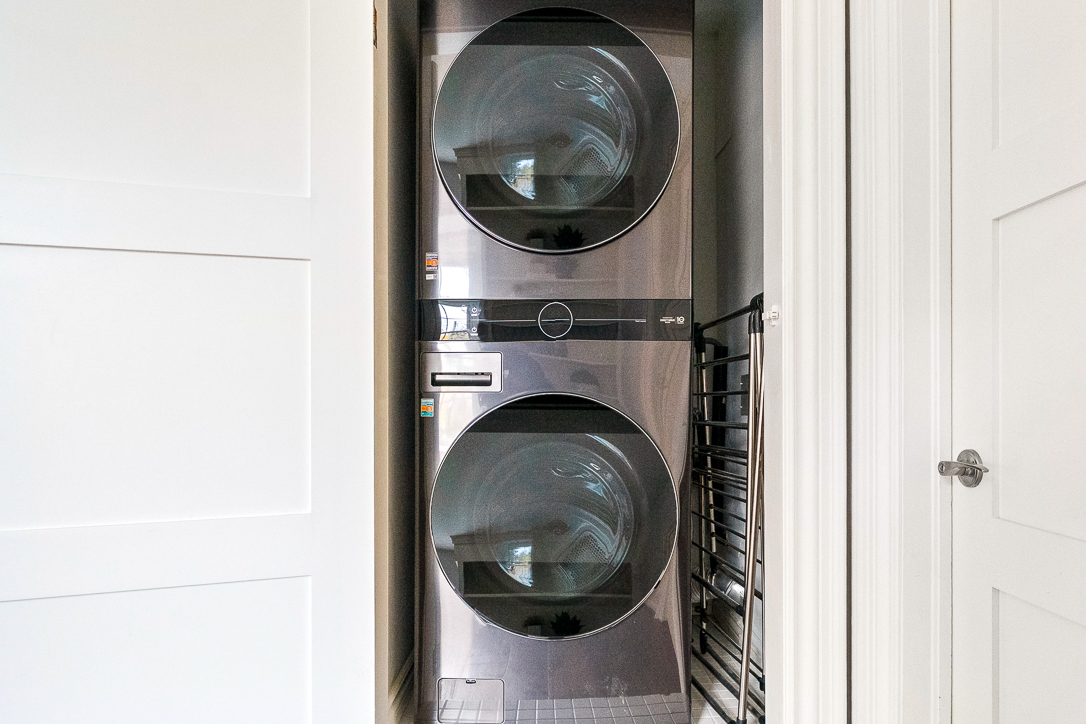Stacked washer and dryer in a modern laundry closet