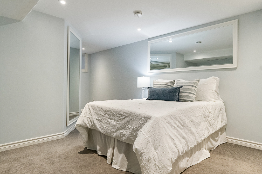 Cozy bedroom with a white bedspread and decorative pillows