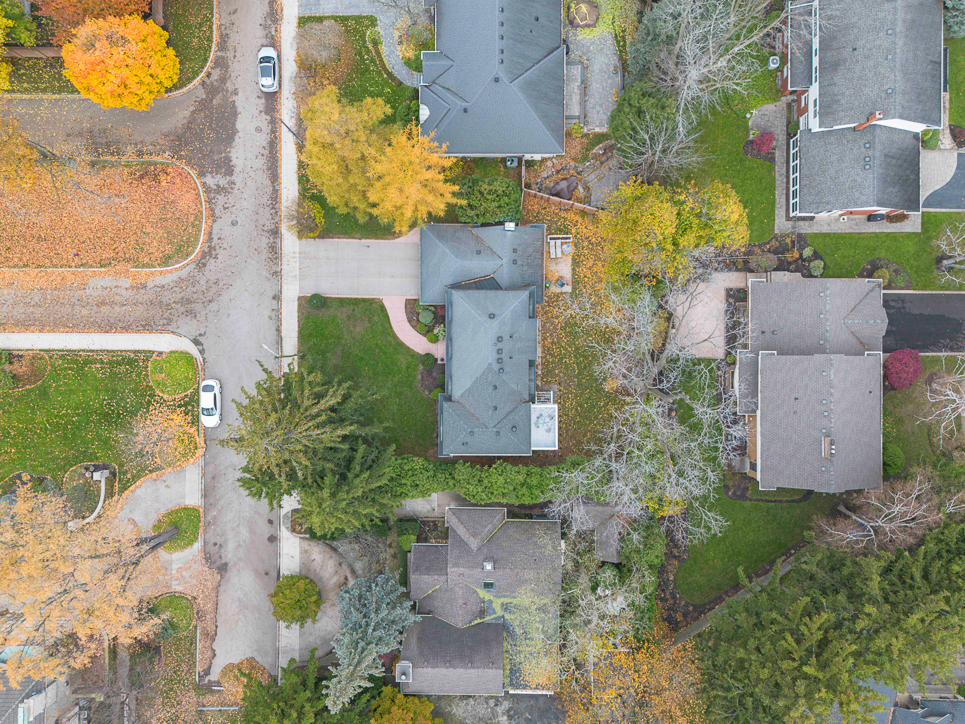 Aerial view of suburban neighborhood with autumn foliage and houses