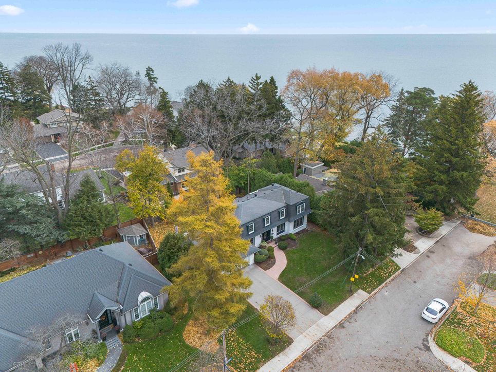 Aerial view of a residential area near a lake with autumn foliage