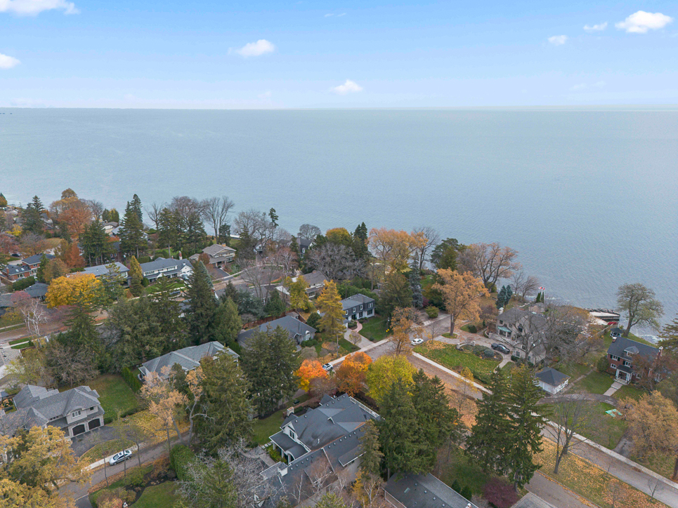 Aerial view of a lakeside neighborhood with autumn foliage