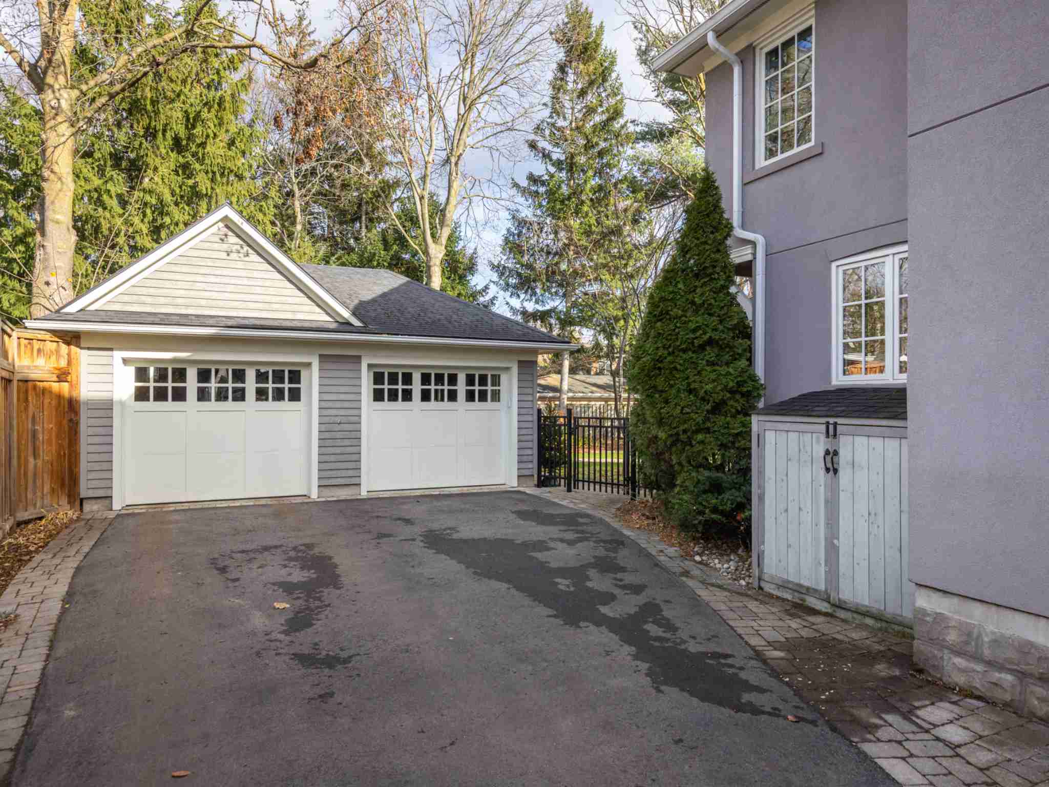 Black top driveway with detached double car garage