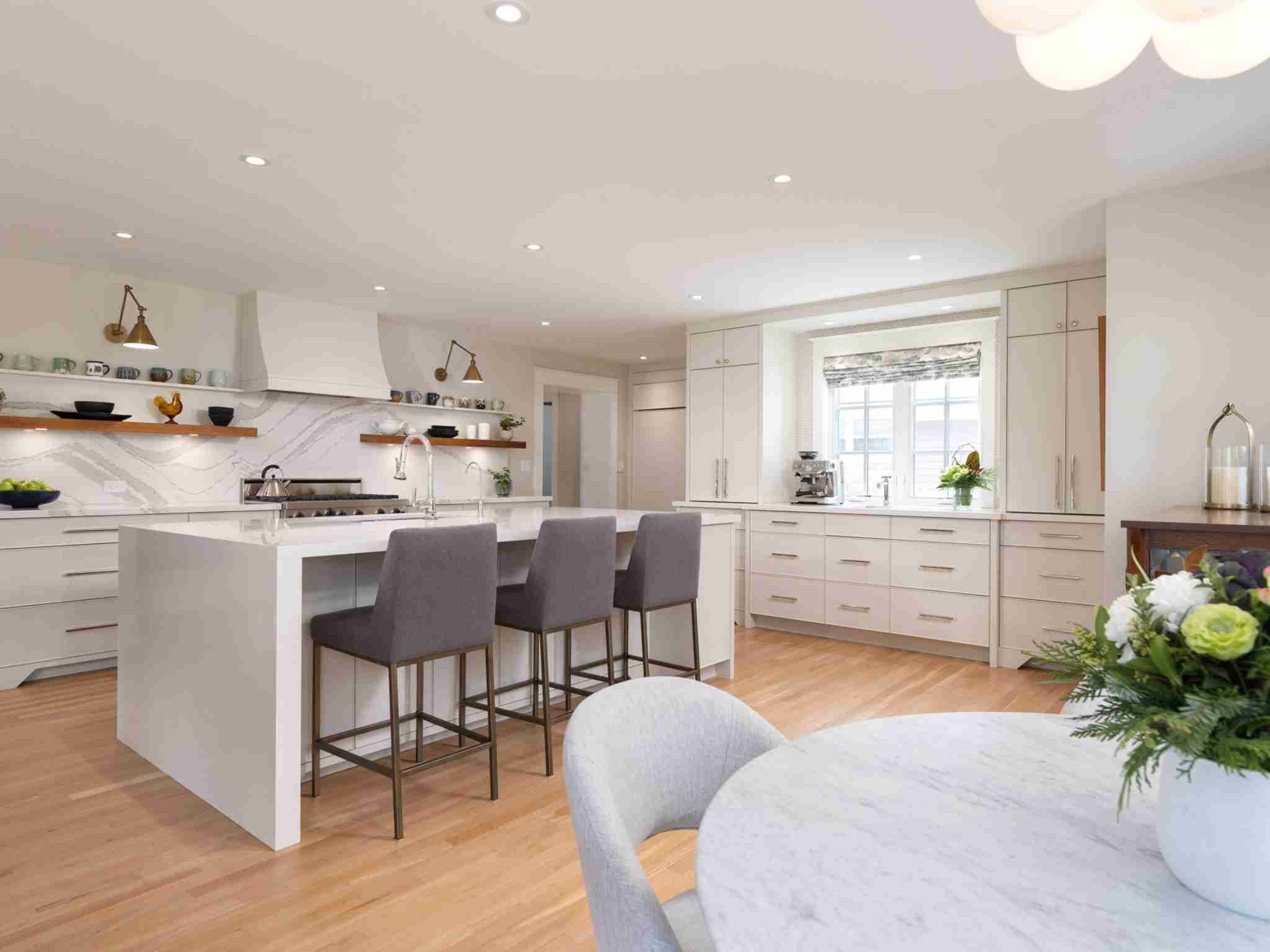 island chairs with cabinets surrounding. large stainless steel appliances