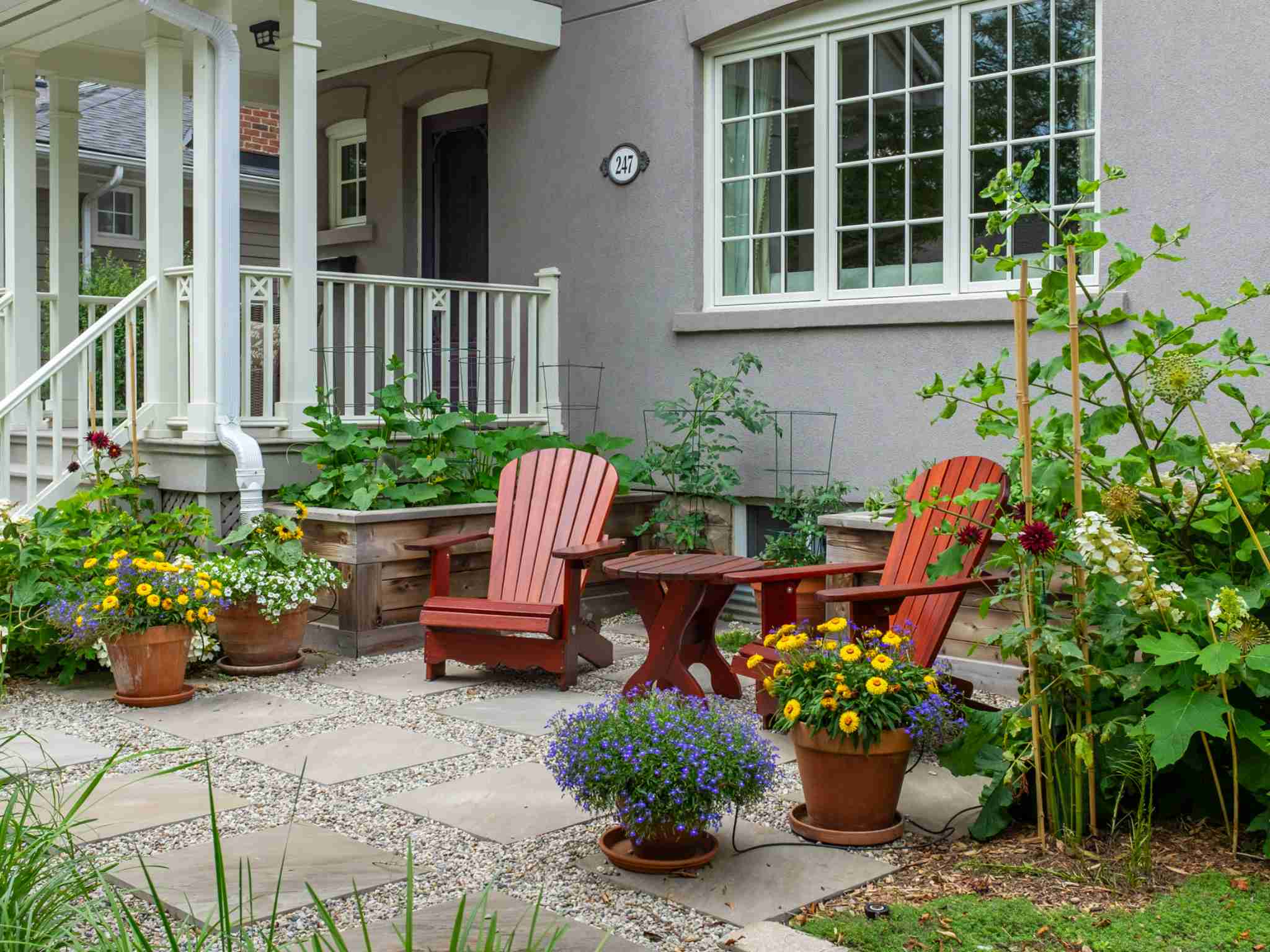 summer photo of front patio with lush gardens
