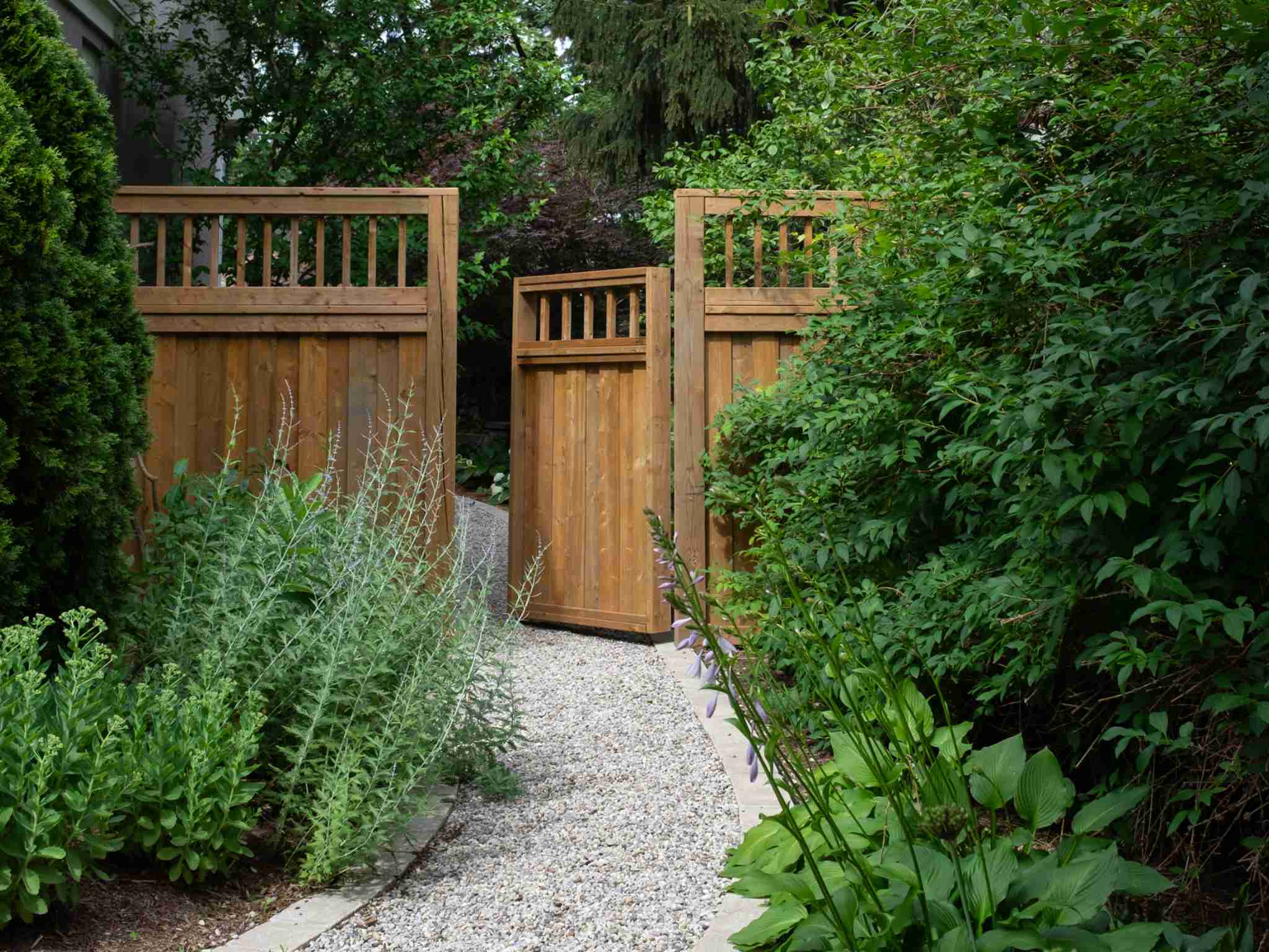 side cedar gate with gravel walk way