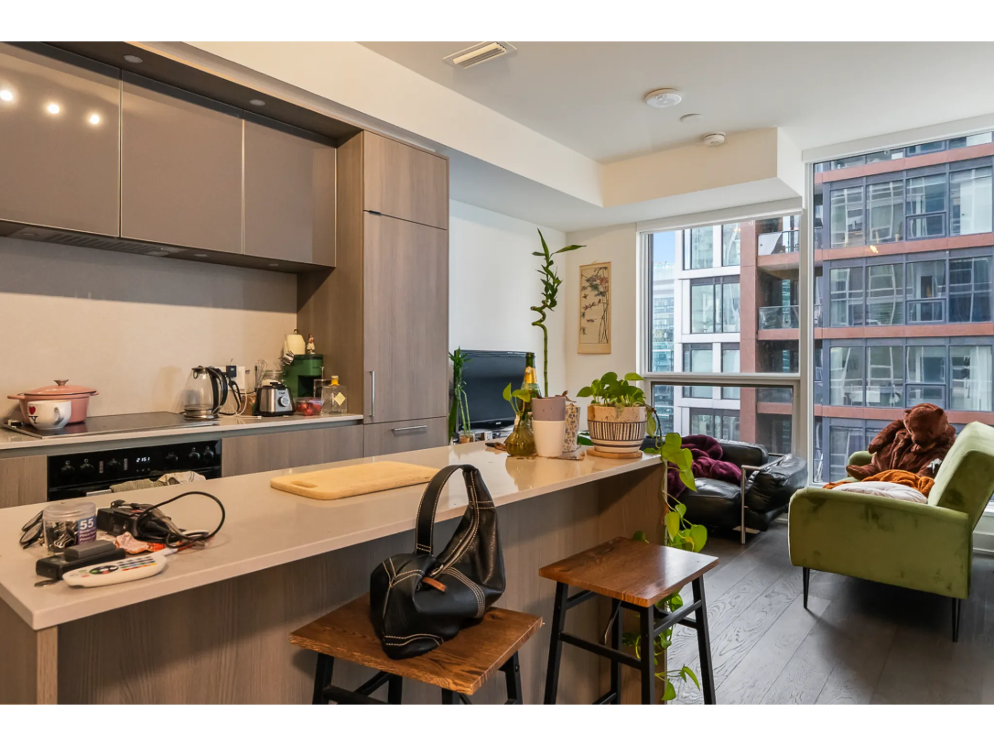 large open space kitchen with pull up bar stools to the island