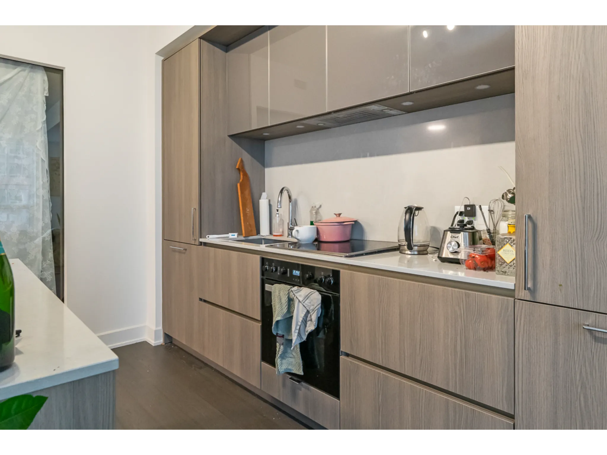 kitchen with lots of storage space, miele appliance and grey backsplash