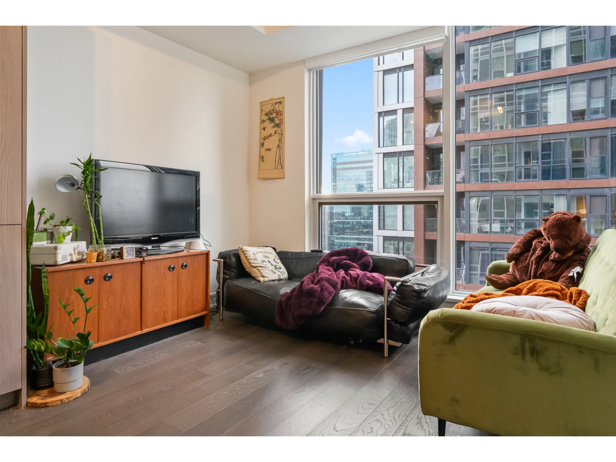 family room with 9ft ceilings and large floor to ceiling windows.