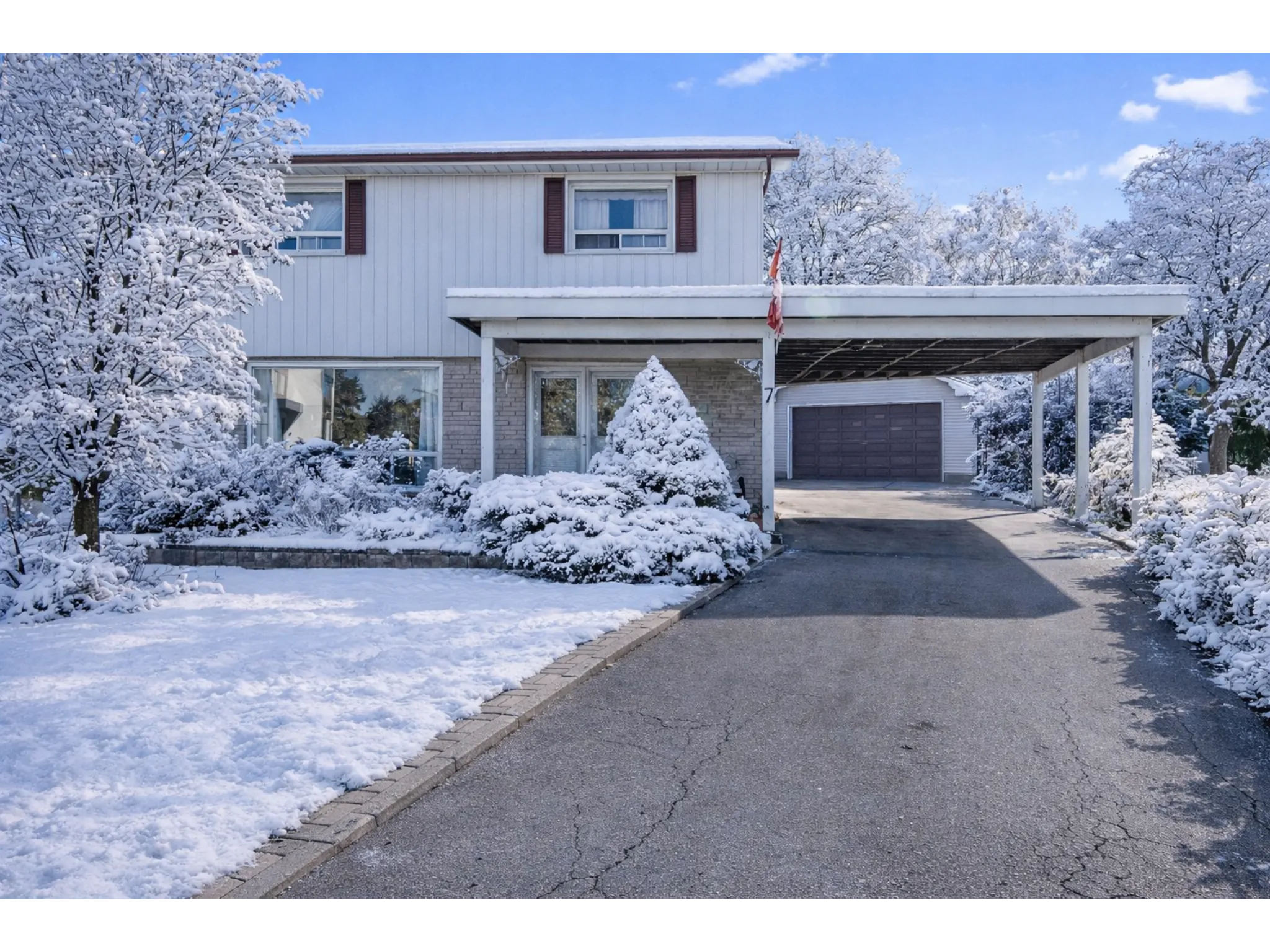 Exterior snow covered photo with double wide driveway