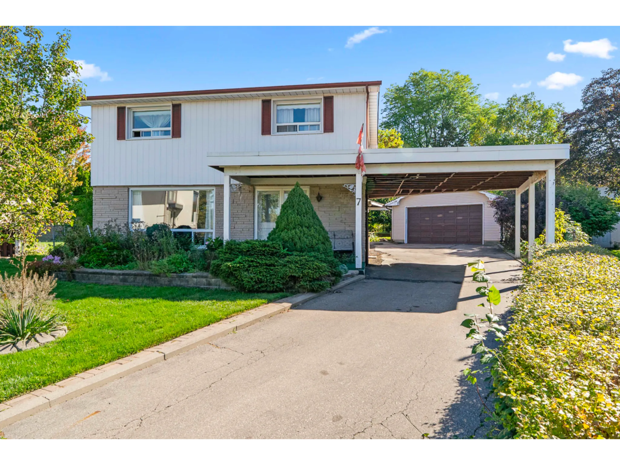 exterior front photo with mature green garden