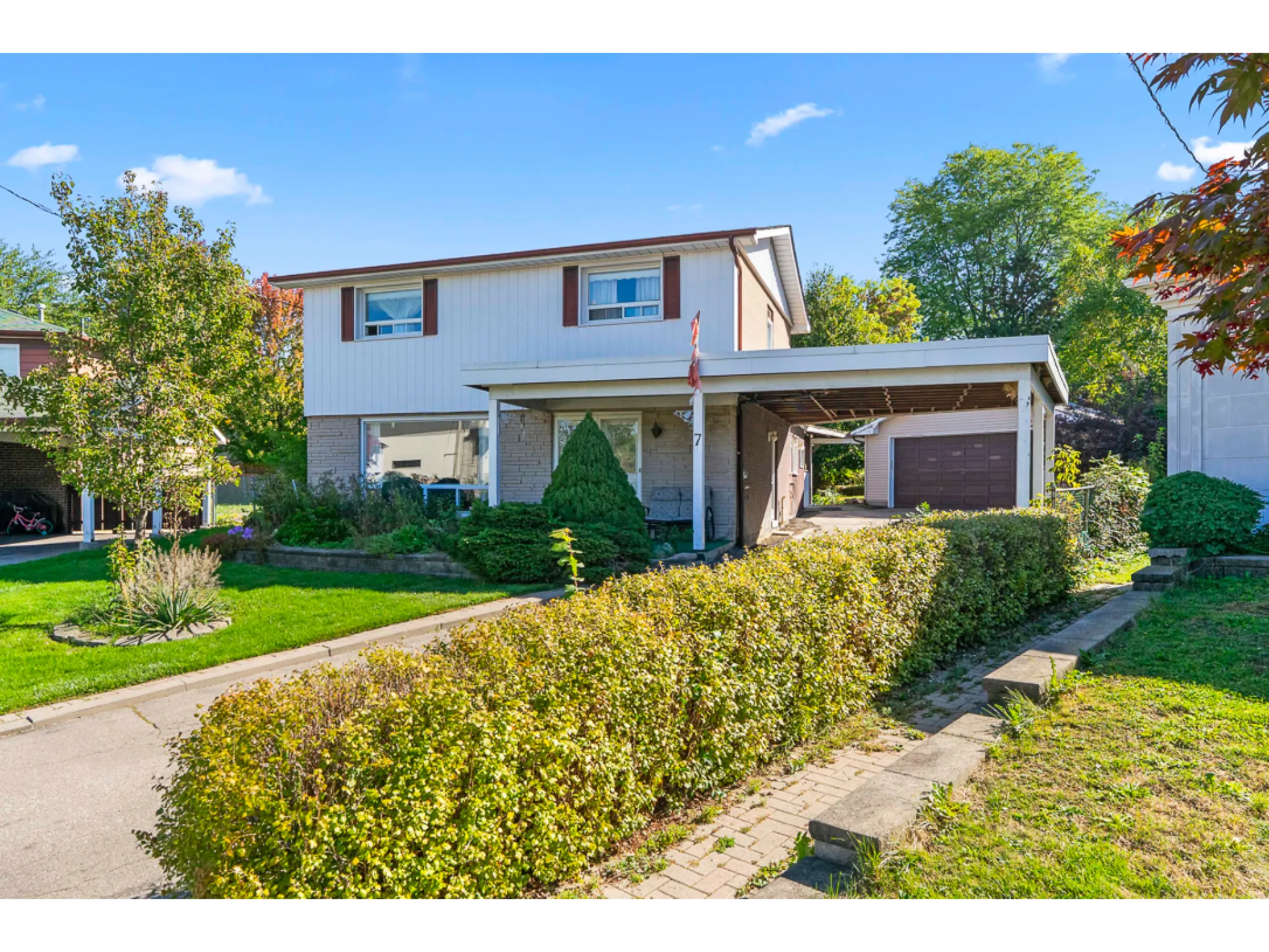 exterior side photo with large trees