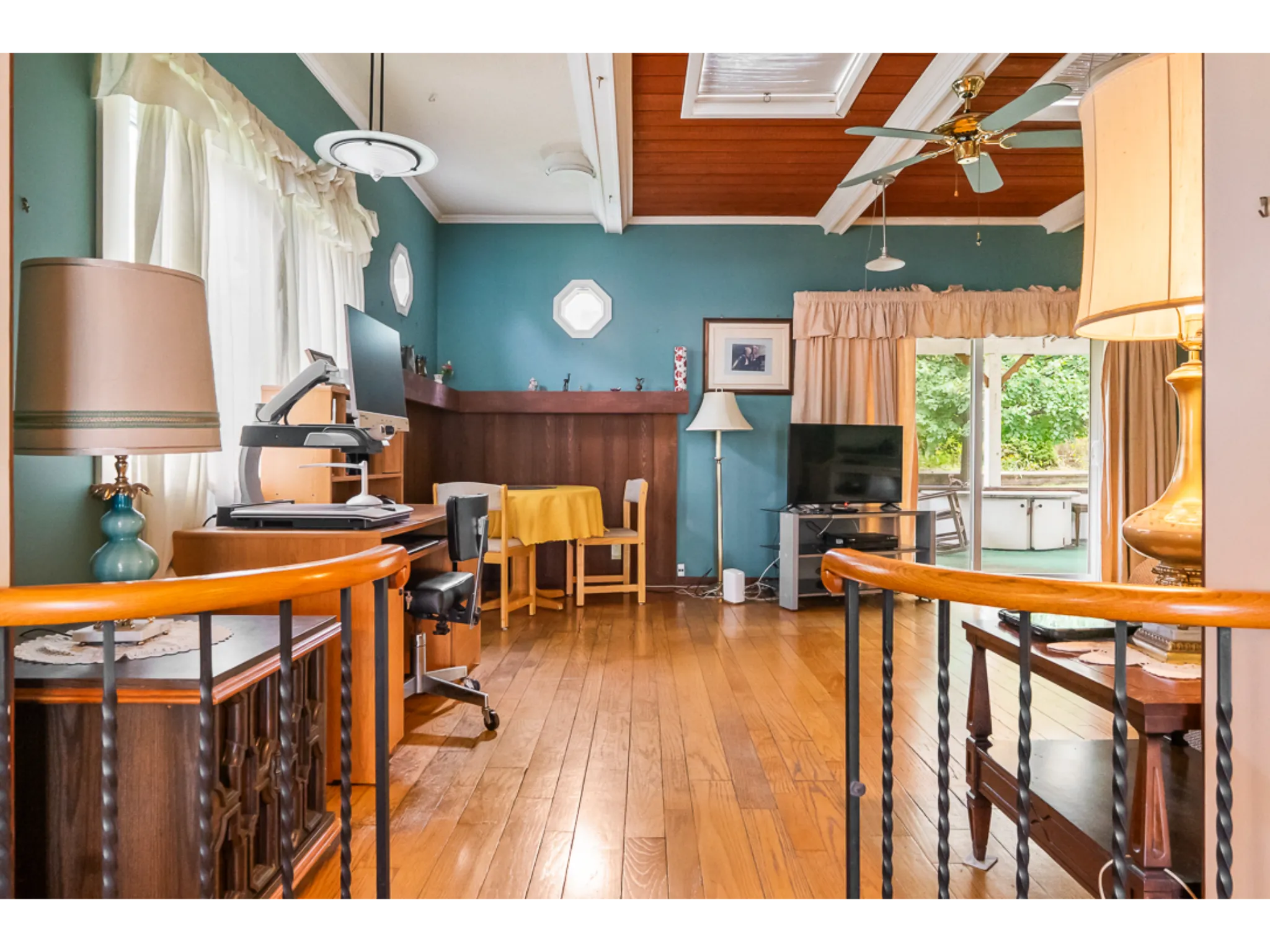 family room with glass sliding door to backyard, hardwood flooring