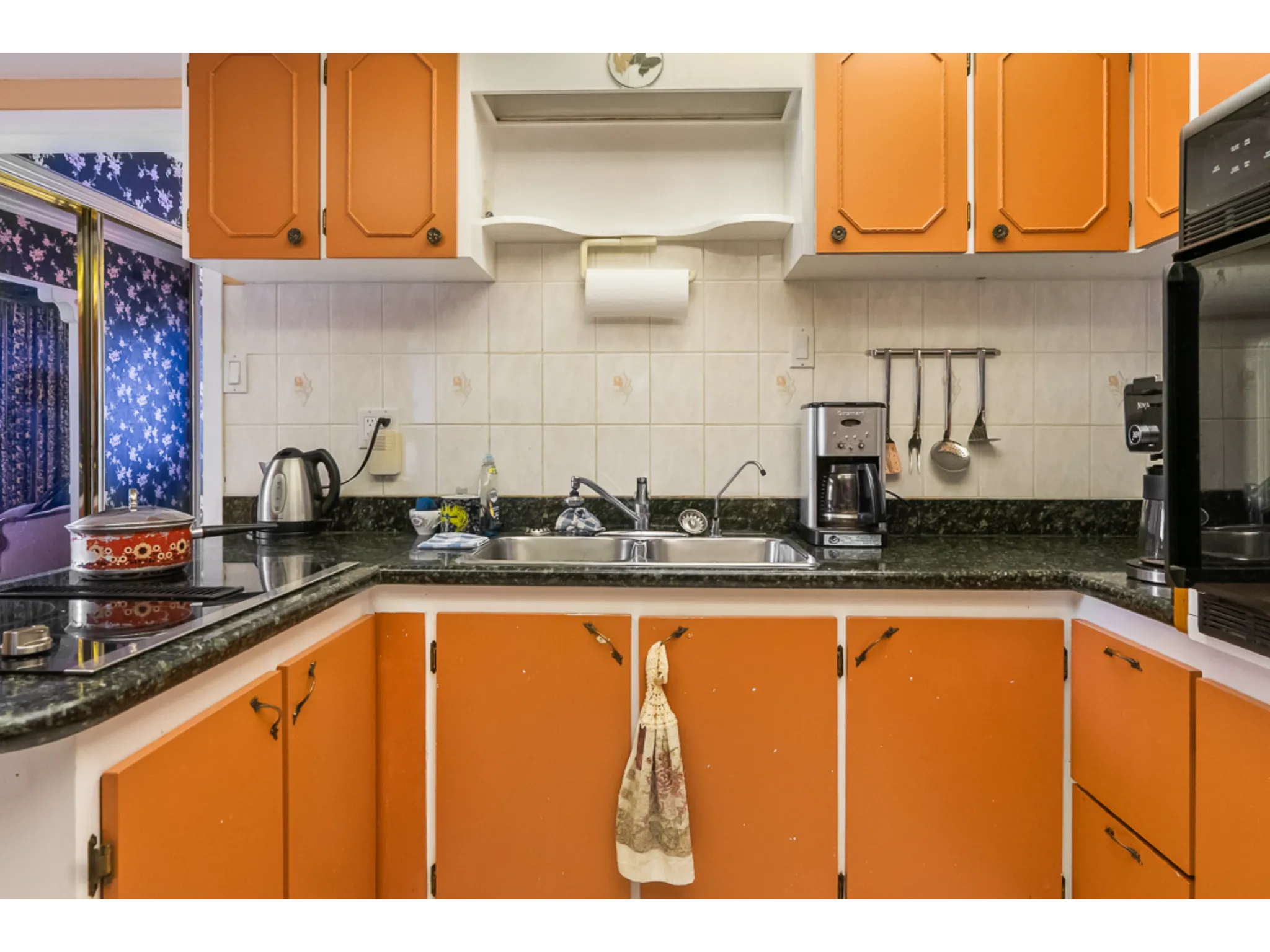 kitchen with plenty of cabinet storage and sunken double sink