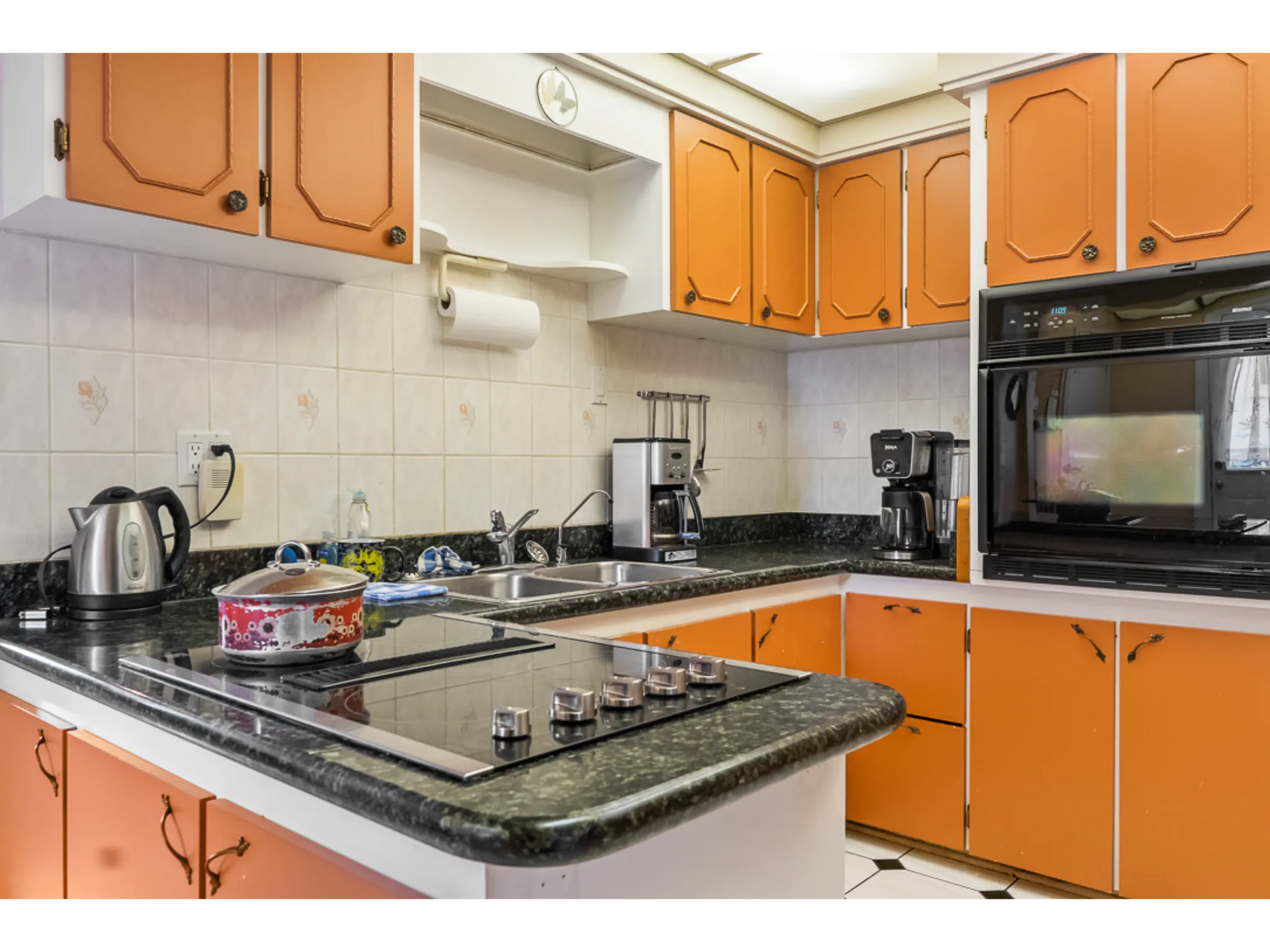 built in counter top stove and black microwave