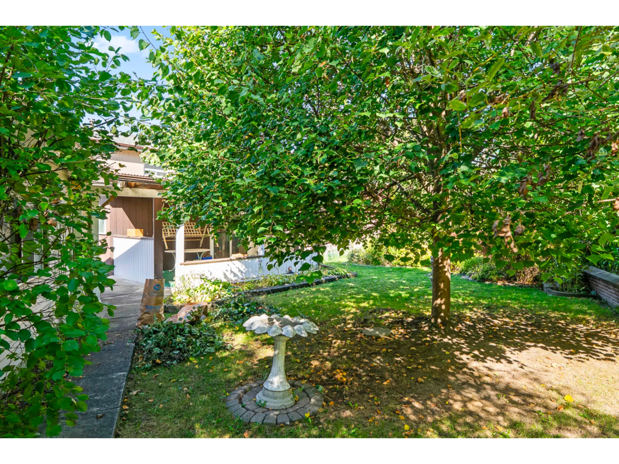 Exterior mature yard with large green grass space