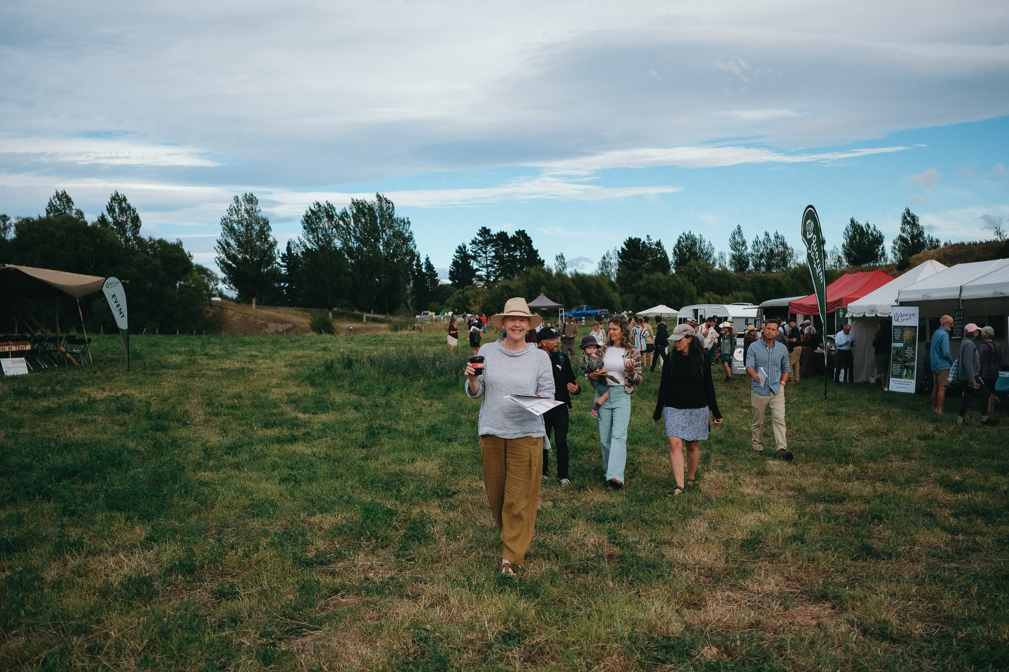 People walking in field facing camera