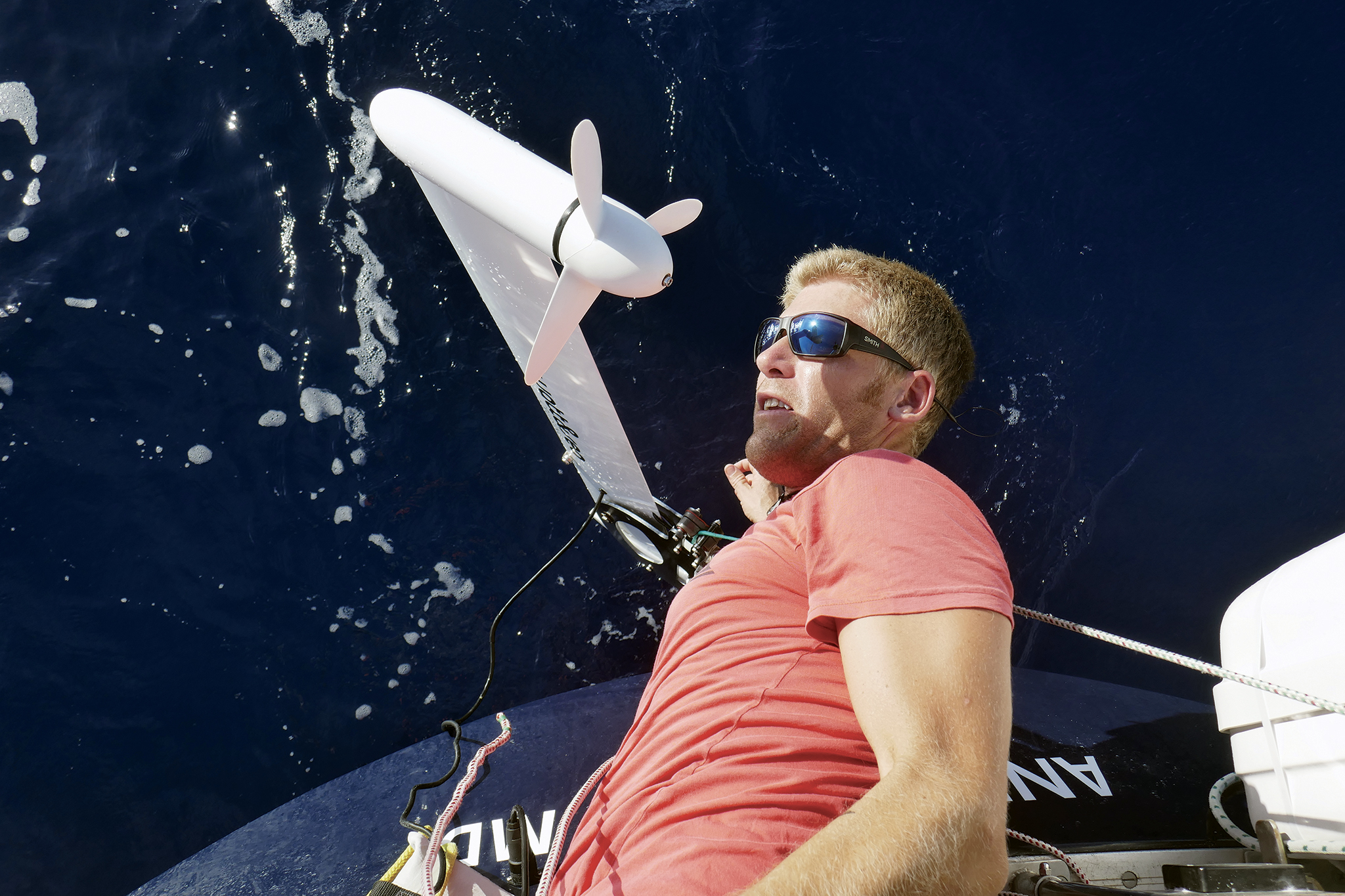 Andy does some inverted boat yoga while working on the Watt & Sea hydrogenerator underway.