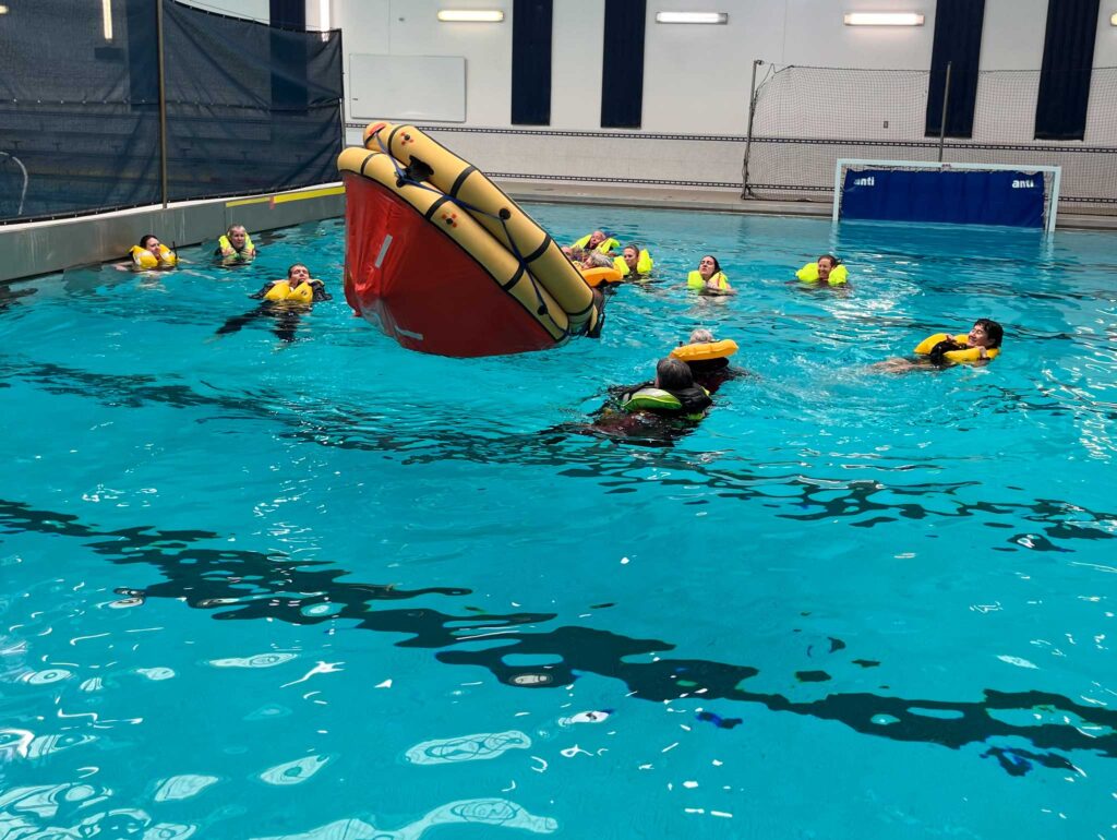 a group of people in a pool with a raft
