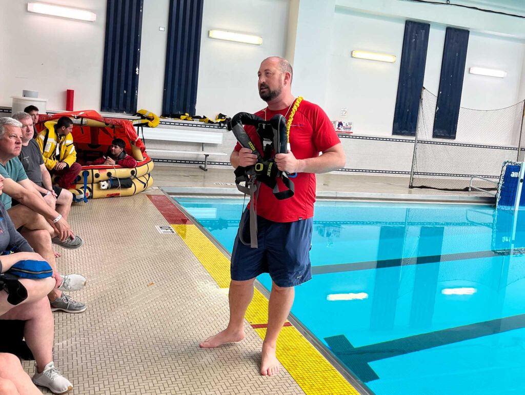 a man standing next to a pool