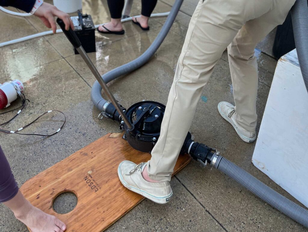 a person using a tool to pump a hole in a wood board