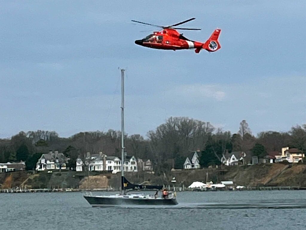 a helicopter flying over a boat