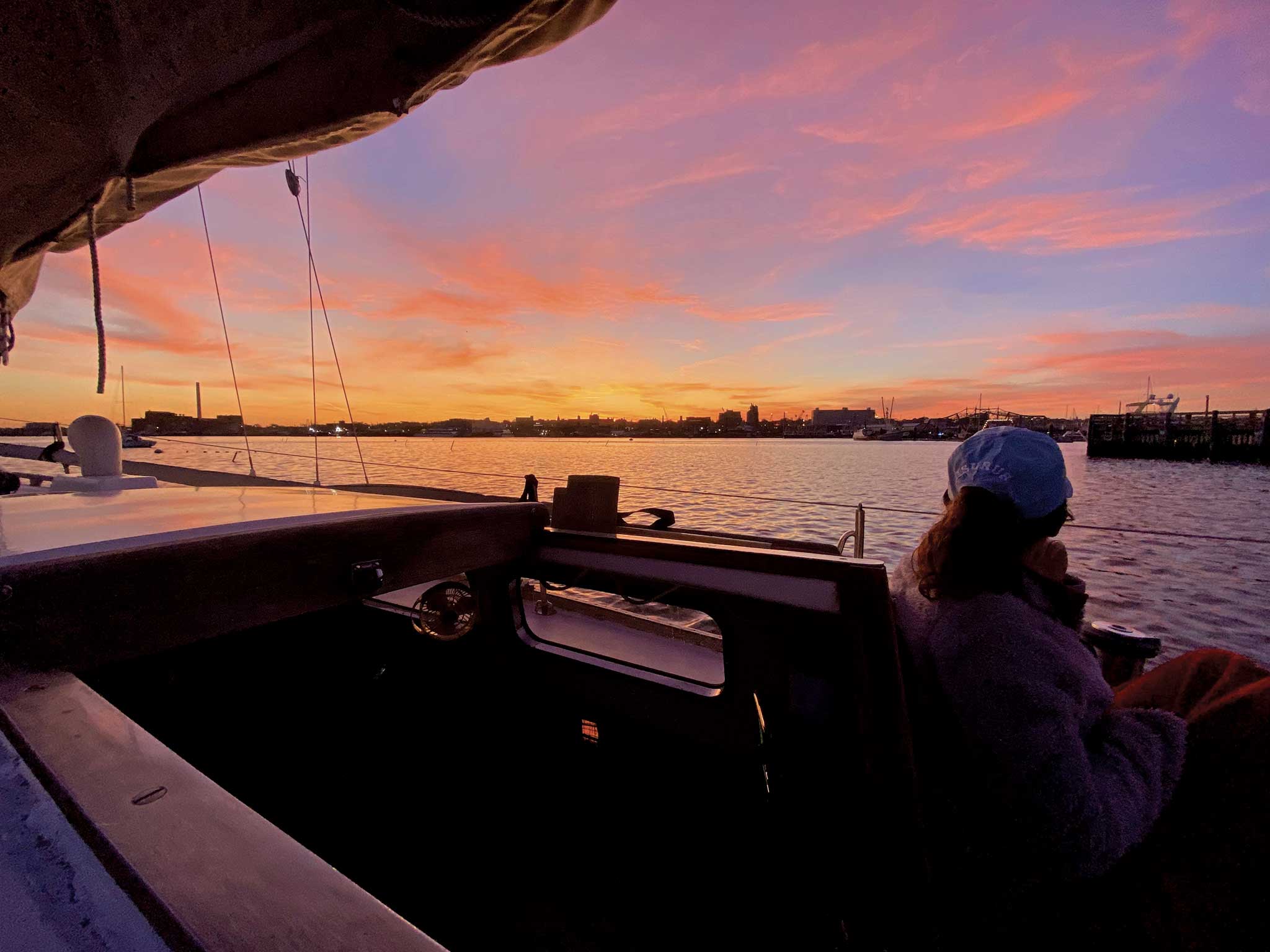 00-LEAD-harbor-burn The author’s wife, Alison, enjoys the peace, quiet, and colors after a sunset sail. Photo by Adam Cove