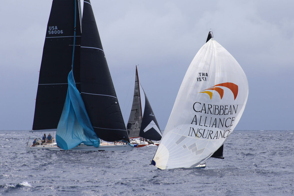 Two boats, one setting a spinnaker, one with it already up