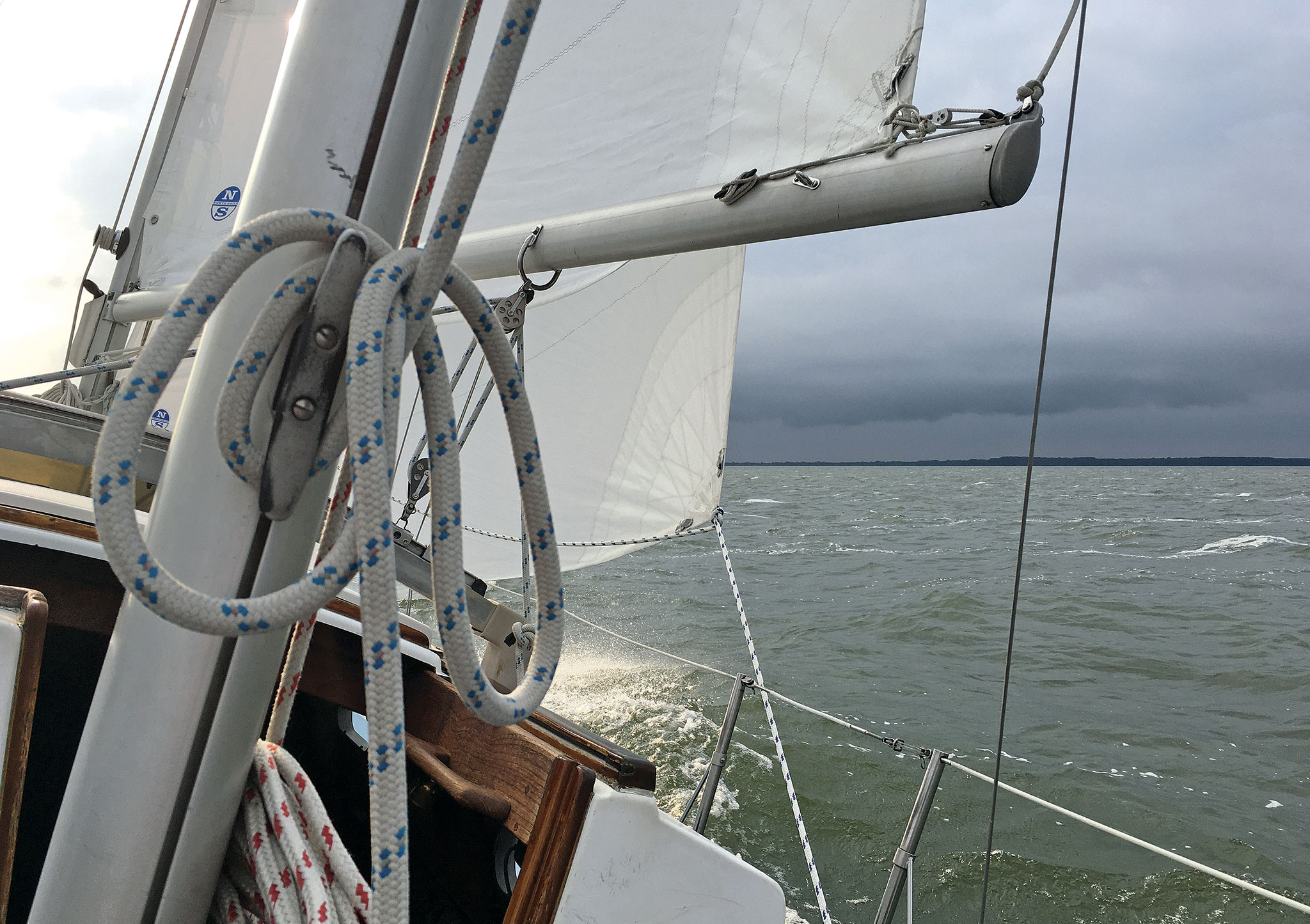 The author’s Cape Dory rolls into a darkening sky. Photo by Robert Wagner