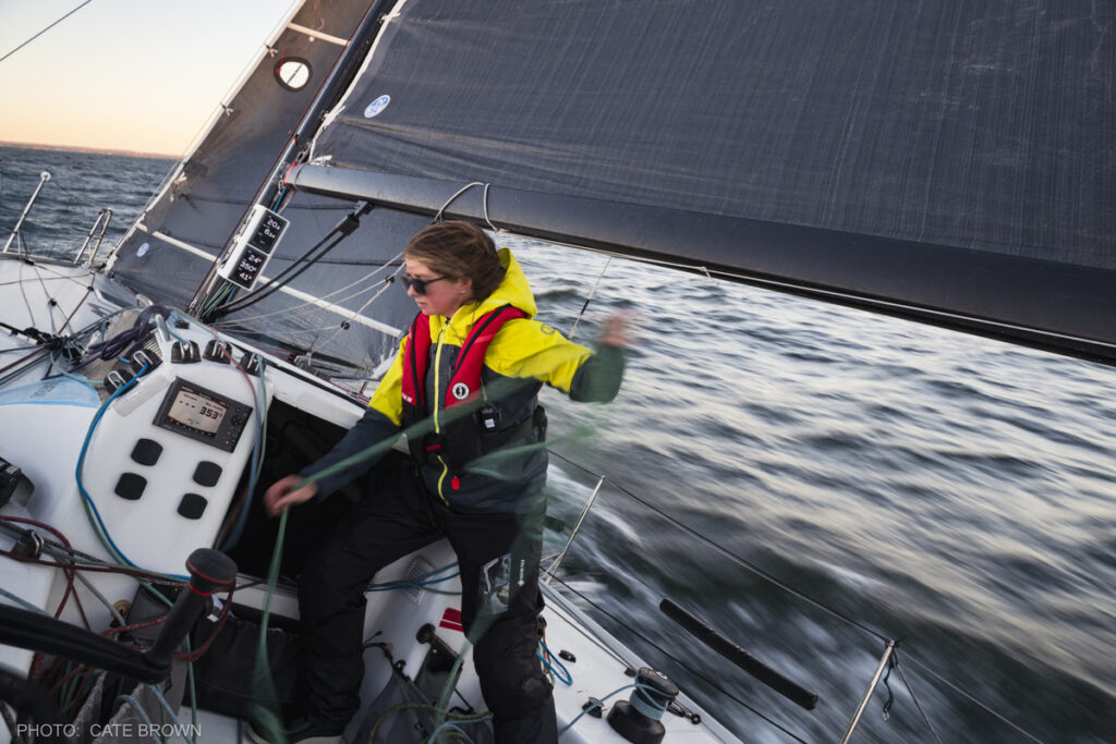 A sailor handling lines on a boat. 