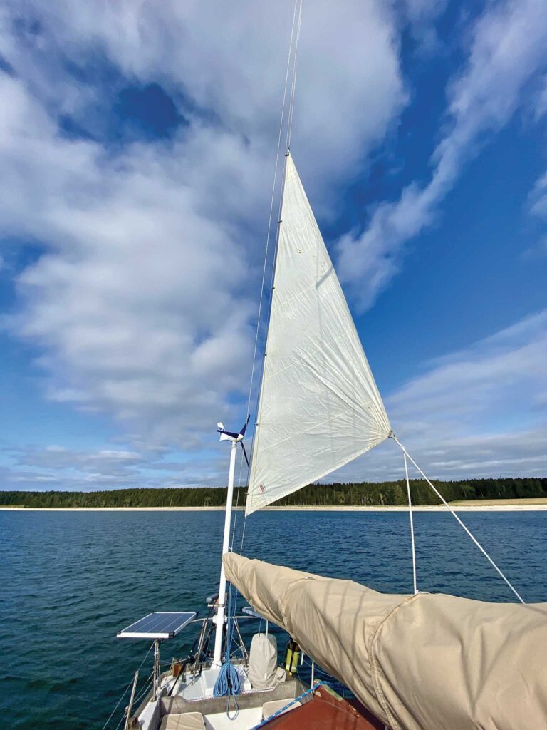 A storm jib hanked to the backstay acts as a makeshift riding sail for directional stability
