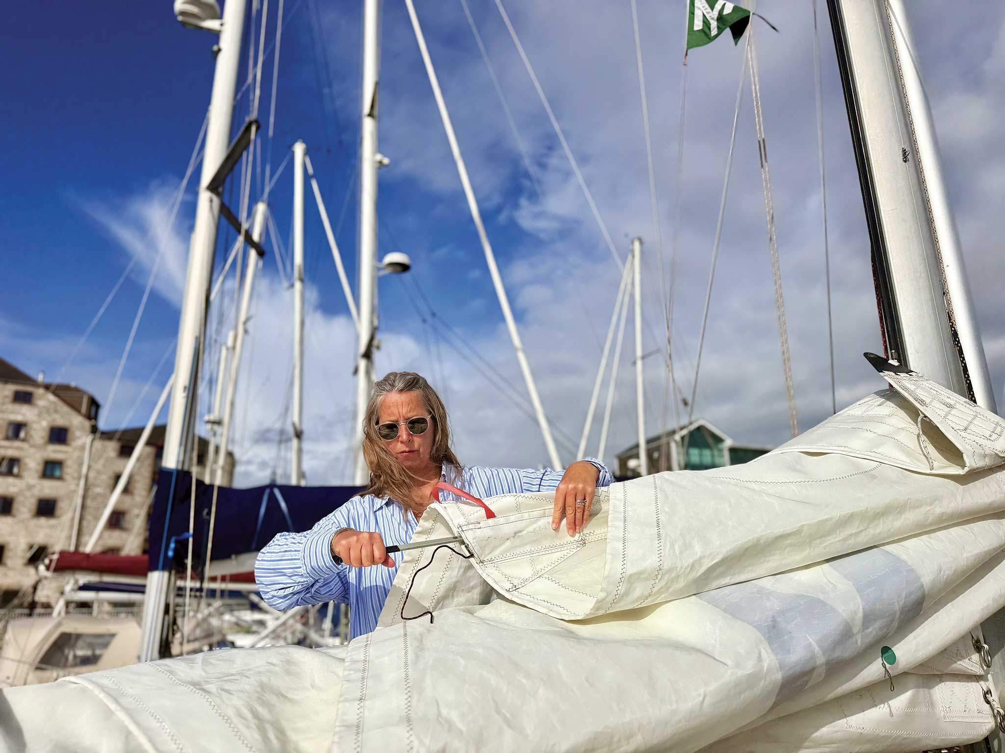 Winterization for Canvas and Sails20251008_150 Alex removes the battens for storage onboard. Photo by Christopher Birch
