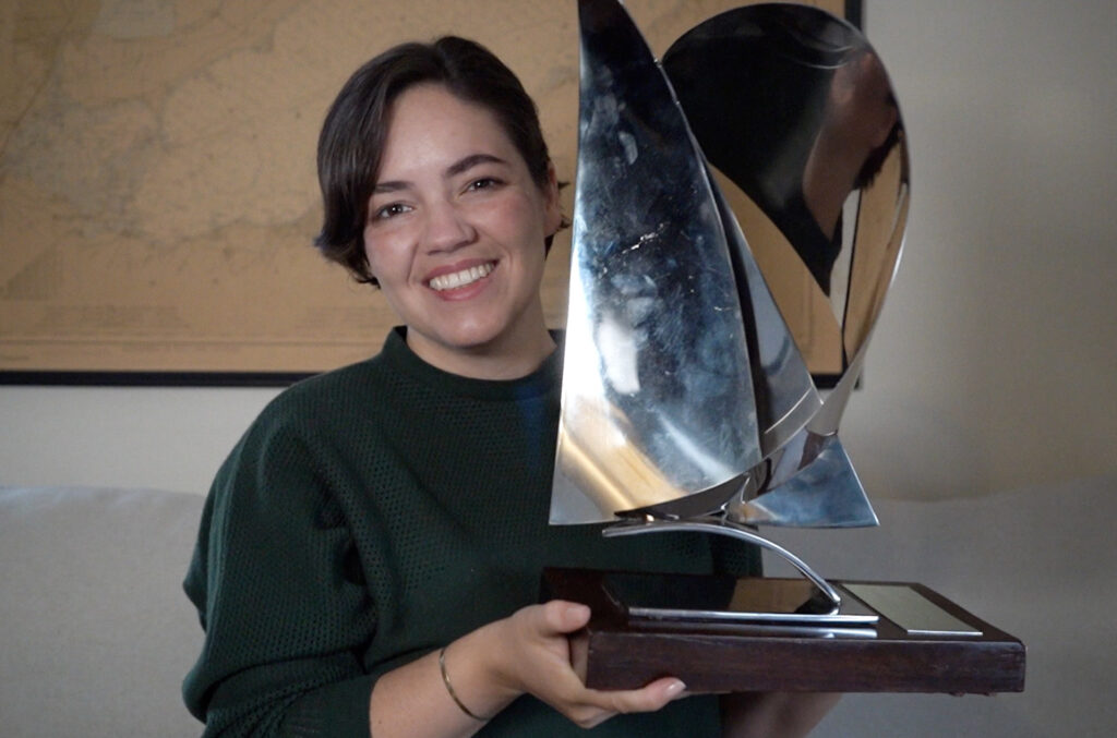 SAIL Editor holds young journalist of the year trophy.
