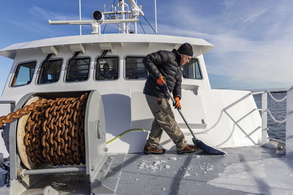 a man shoveling a boat