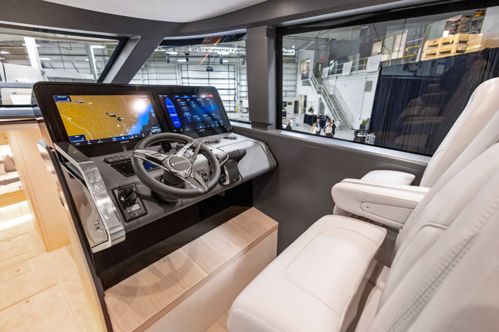 a steering wheel and dashboard of a boat