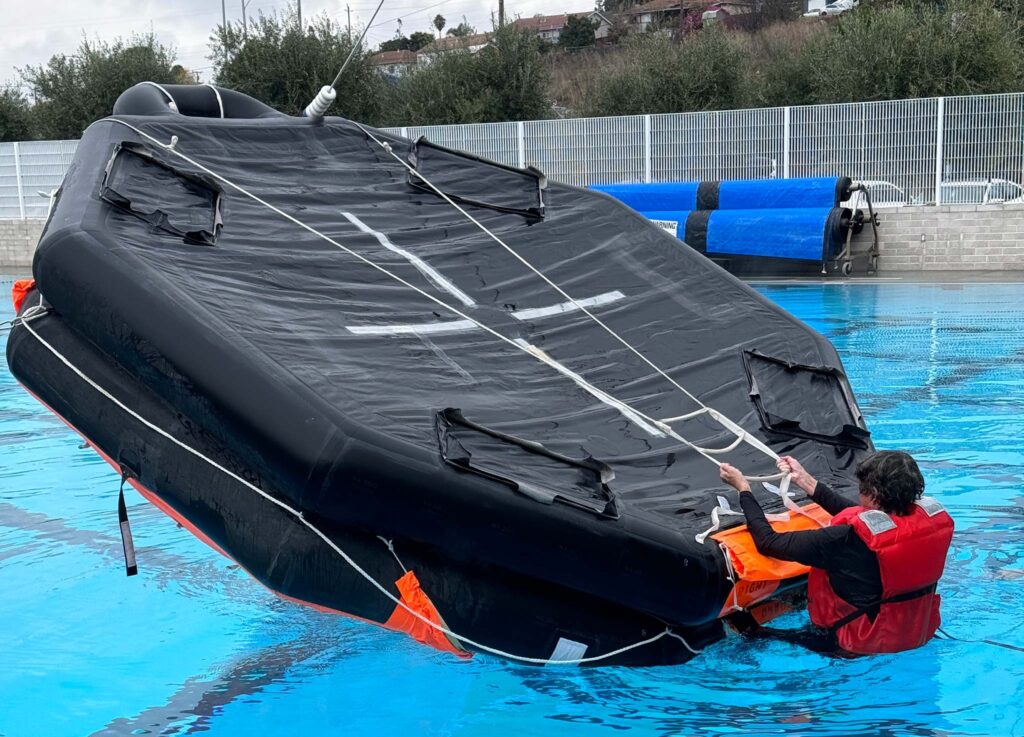 a person lifting a black object in a pool