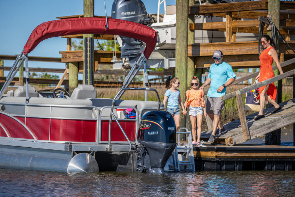 Family next to a pontoon boat