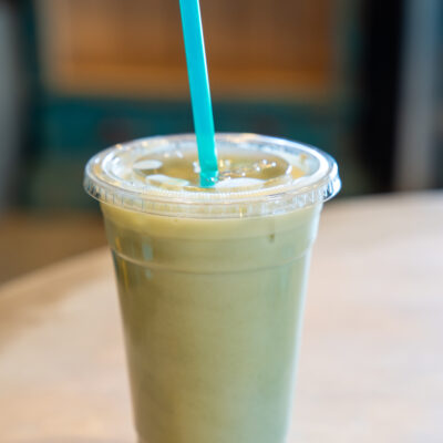 Iced matcha served in a plastic cup.