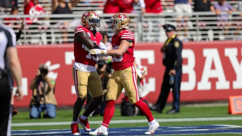 Oct 1, 2023; Santa Clara, California, USA; San Francisco 49ers running back Christian McCaffrey (23) celebrates with wide receiver Deebo Samuel (19) after a scoring a touchdown during the second quarter against the Arizona Cardinals at Levi's Stadium. Mandatory Credit: Sergio Estrada-USA TODAY Sports